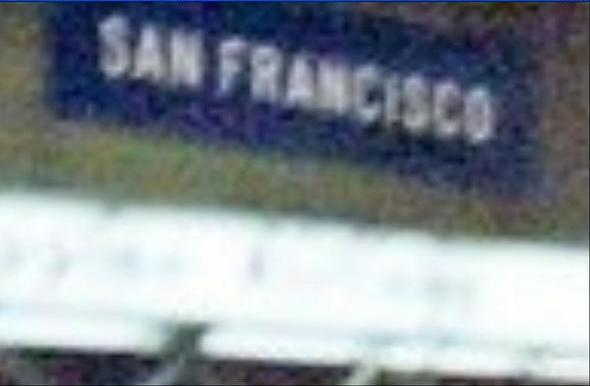Close-up of the 'San Francisco' sign inside the airport terminal.