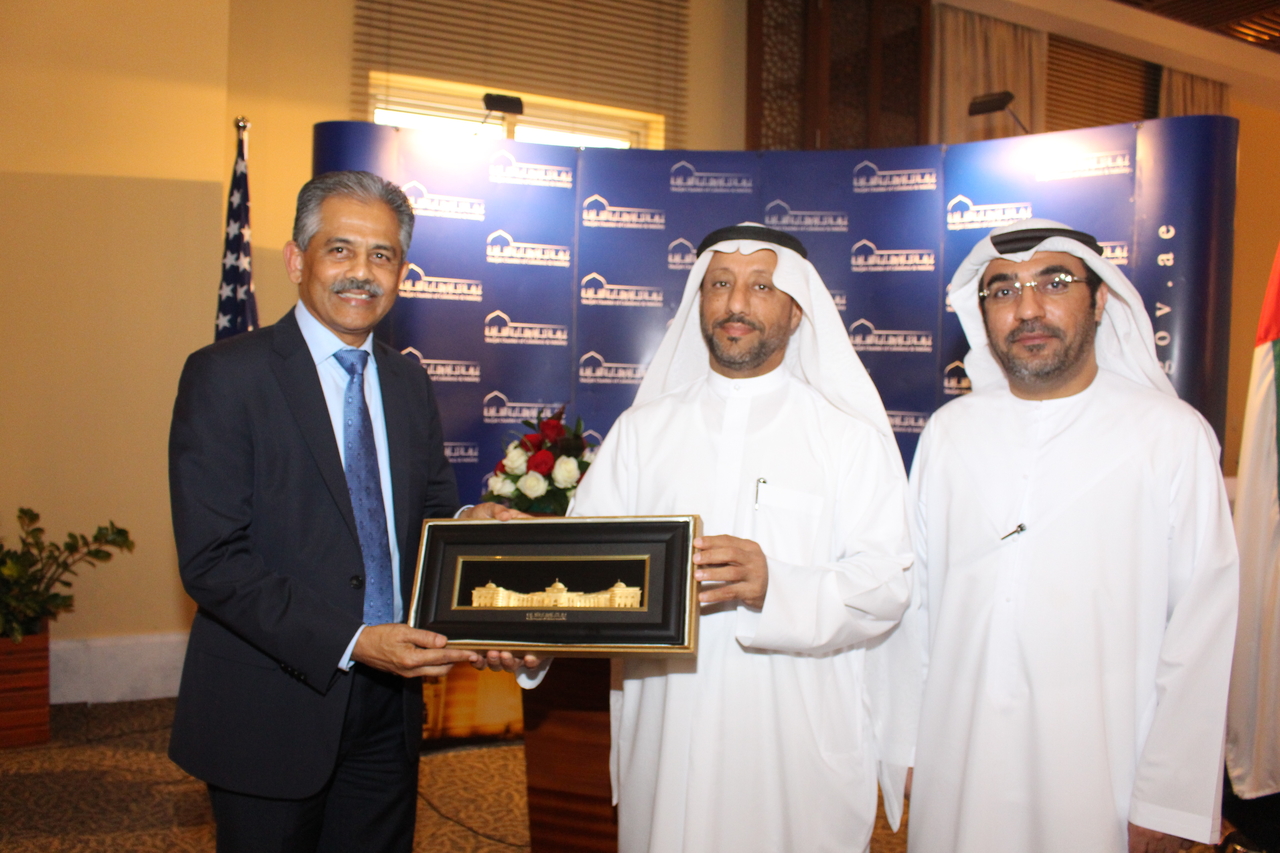 SHARJAH, UAE - FEBRUARY 19, 2015 - SelectUSA Director Ambassador Vinai Vinay Thummalappally appears to be receiving a gift during a luncheon in his honor sponsored by the Sharjah Chabmer of Commerce and Industry. Crescent and Gulftainer are headquartered in Sharjah.